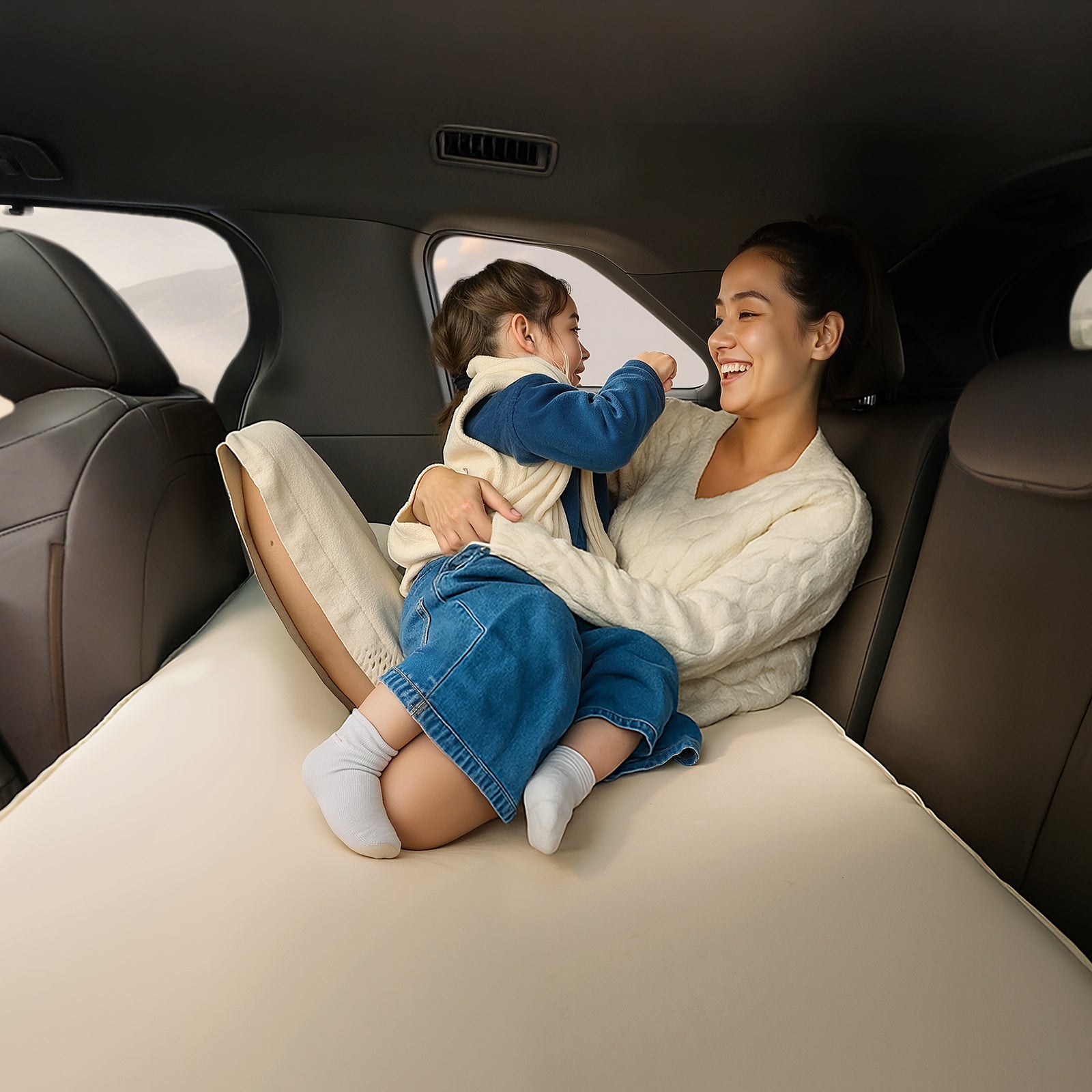 Mother and child relaxing on Havnby Air Foam 3rd row mattress in Toyota Sienna